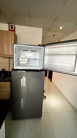 Compact grey top-freezer refrigerator in excellent condition