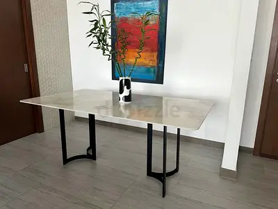 Marble-top dining table with black metal legs - good condition