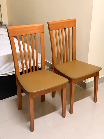 Pair of wooden slat-back dining chairs with cushioned seats