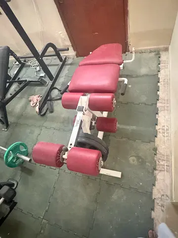Used multi-function home gym bench with leg curl/extension attachment