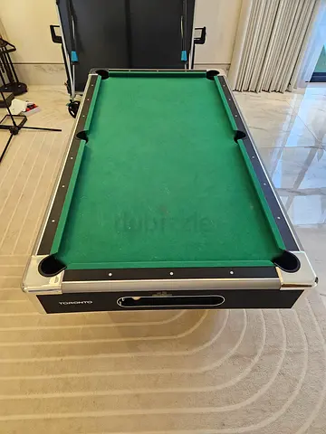 Billiards table with cues and balls