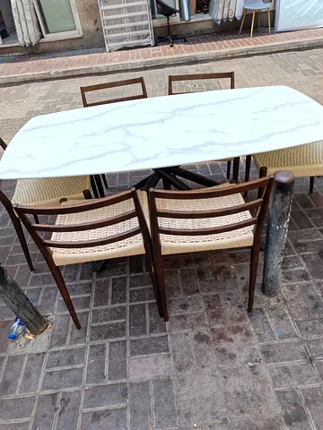6-piece dining table set with white marble-look top and rattan chairs