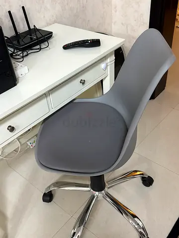 Grey ergonomic swivel office chair on wheels - good condition