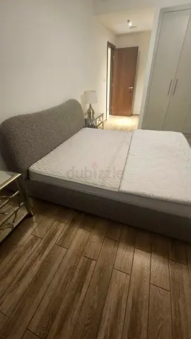 Grey upholstered double bed frame with headboard - good condition