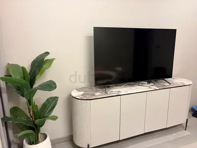 Gray rounded TV cabinet with marble top - good condition