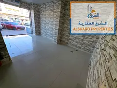 A large commercial shop available for annual rent in Al Rawda 2, Ajman, located in a new building di