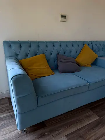 Light blue tufted 8-seater sofa in good condition