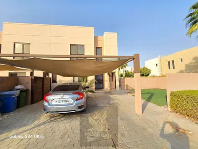 Villa for rent in Al Zahia, Sharjah, featuring 4 bedrooms, a living room, a majlis, a maid's room, a private garden, and covered parking within a gate