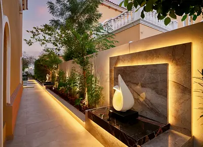 Outdoor pathway lighting with decorative water feature and planters