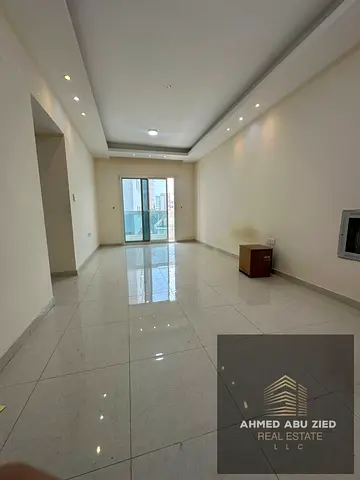 2BR + Hall for annual rent in Ajman, 2 master bedrooms, spacious hall, balcony, central AC, modern