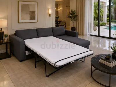 Grey L-shaped sofa with pull-out bed - good condition
