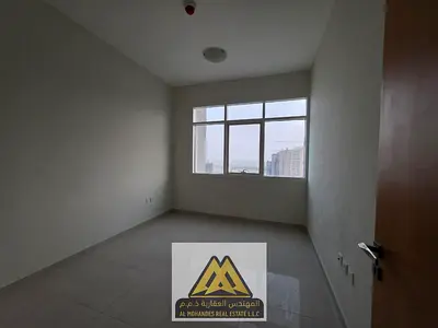 Two bedrooms and a living room, parking, prime location in Emirates City, Golf Tower, excellent location with all services and easy access to Sharjah