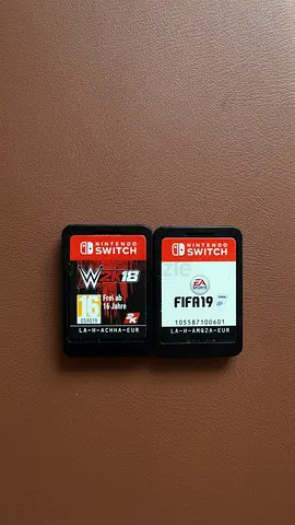 Two Nintendo Switch game cartridges: FIFA 19 & WWE 2K18 (used)