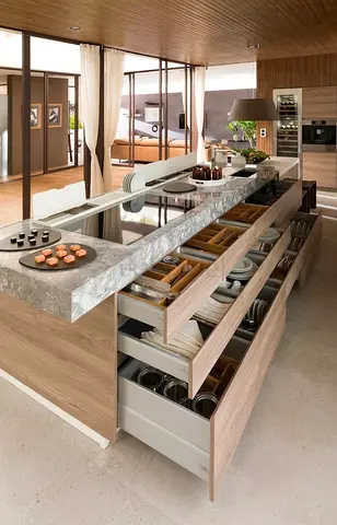 Modern kitchen island with multiple pull-out drawers and marble countertop