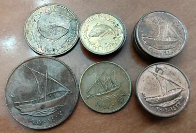 UAE old coins and one Kuwaiti 5 fils coin
