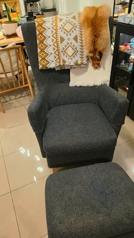 Comfortable grey armchair with ottoman — used