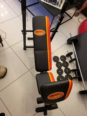 Adjustable weight bench with barbell and plates set - used