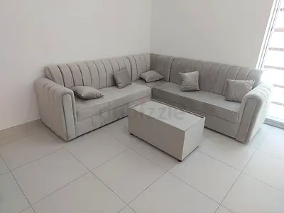 Light grey L-shaped velvet corner sofa with storage coffee table