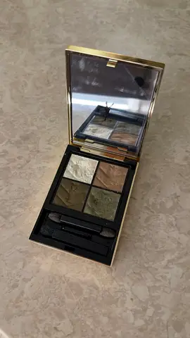 Used eyeshadow palette — neutral/olive shades, mirror included