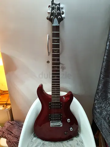 Used electric guitar - solid body, red finish, double humbuckers (PRS CE24 copy)