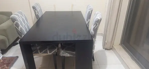 Used black dining table with 4 patterned chairs - sturdy, good condition
