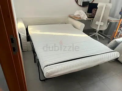 White fold-out sofa bed with mattress (pull-out guest bed)