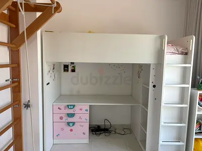 White loft bunk bed with built-in desk and shelves, pink drawers