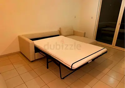 Beige fabric sofa bed with pull-out mattress - good condition