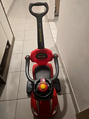 Red baby push car with lights music and parent handle - good condition