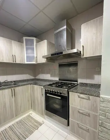 L-shaped kitchen cabinets with granite countertops