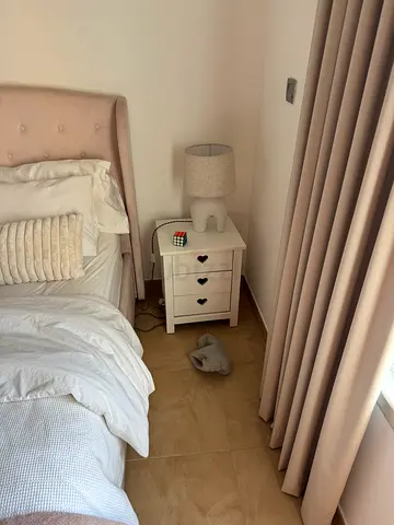 Girls pink king size bed with matt, White wooden bedside table with 3 drawers, White dressing table.