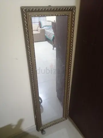 Full-length decorative standing mirror with ornate frame