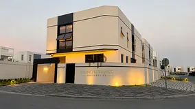 Corner villa for sale in Al Bahia - Ajman | Two floors and a roof, 5 master rooms 3,500 ft² | Moder