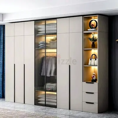 Modern built-in wardrobe with glass doors and illuminated shelving