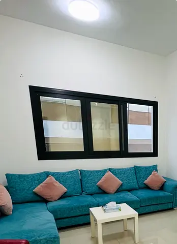 Teal L-shaped Fabric Sofa with Cushions - Good Condition