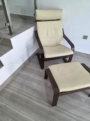 IKEA Poäng-style armchair with footstool - dark wood frame, cream cushions