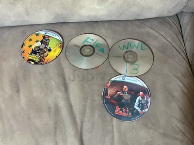 Collection of 4 used game/movie discs (Xbox/PC), some handwritten labels, playable condition unknown