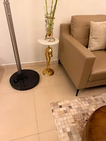 Modern round marble-top side table with gold horse stand
