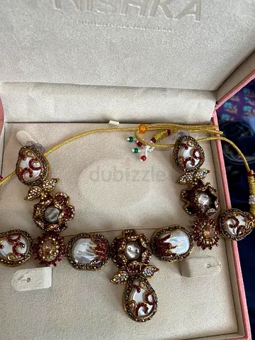 Traditional Kundan-style Necklace Set with Pearls and Red Stones