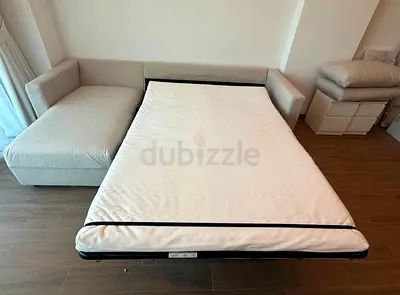 Light grey L-shaped sofa with pull-out bed, good condition
