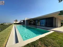 Villa for sale in Al-Zoura area, on the sea, surrounded by stunning natural beauty. Custom-finished