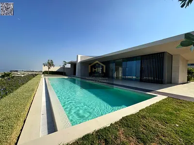 Villa for sale in Al-Zoura area, on the sea, surrounded by stunning natural beauty. Custom-finished and elegantly designed. Freehold ownership availab