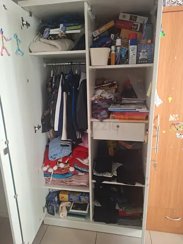Wardrobe with mixed men's and women's clothing - ready to pick items