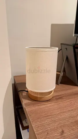 Small wooden base table lamp with cream fabric shade