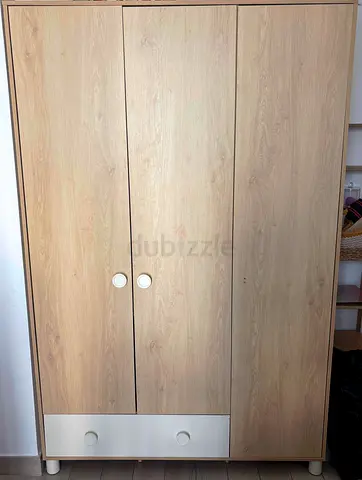 Light wood 3-door wardrobe with bottom drawer - good condition.  200 x 130 x 60 cm.