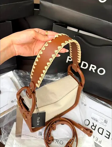 Brown leather-trim canvas shoulder bag with wide stitched strap