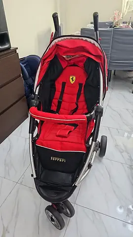 Red Ferrari-branded baby stroller in good condition