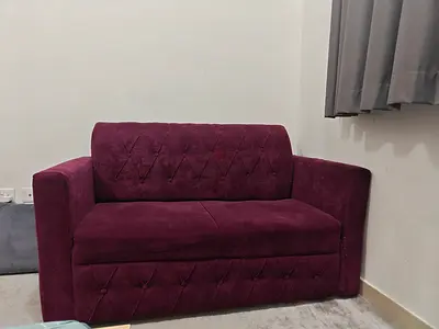 Compact two-seater purple velvet sofa - good condition