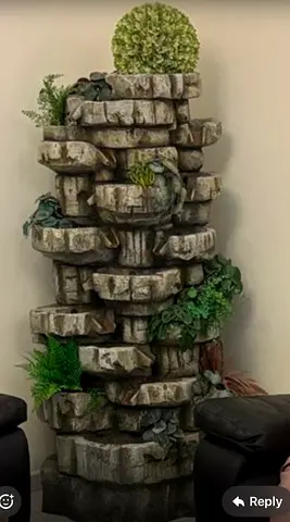 Indoor decorative stone fountain with faux plants