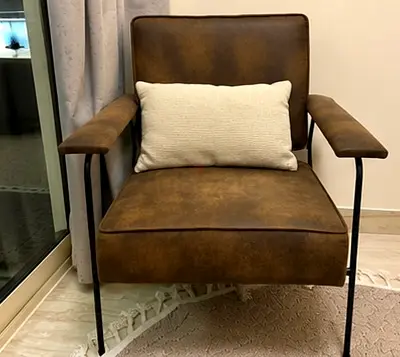 Brown leather-look accent armchair with metal frame